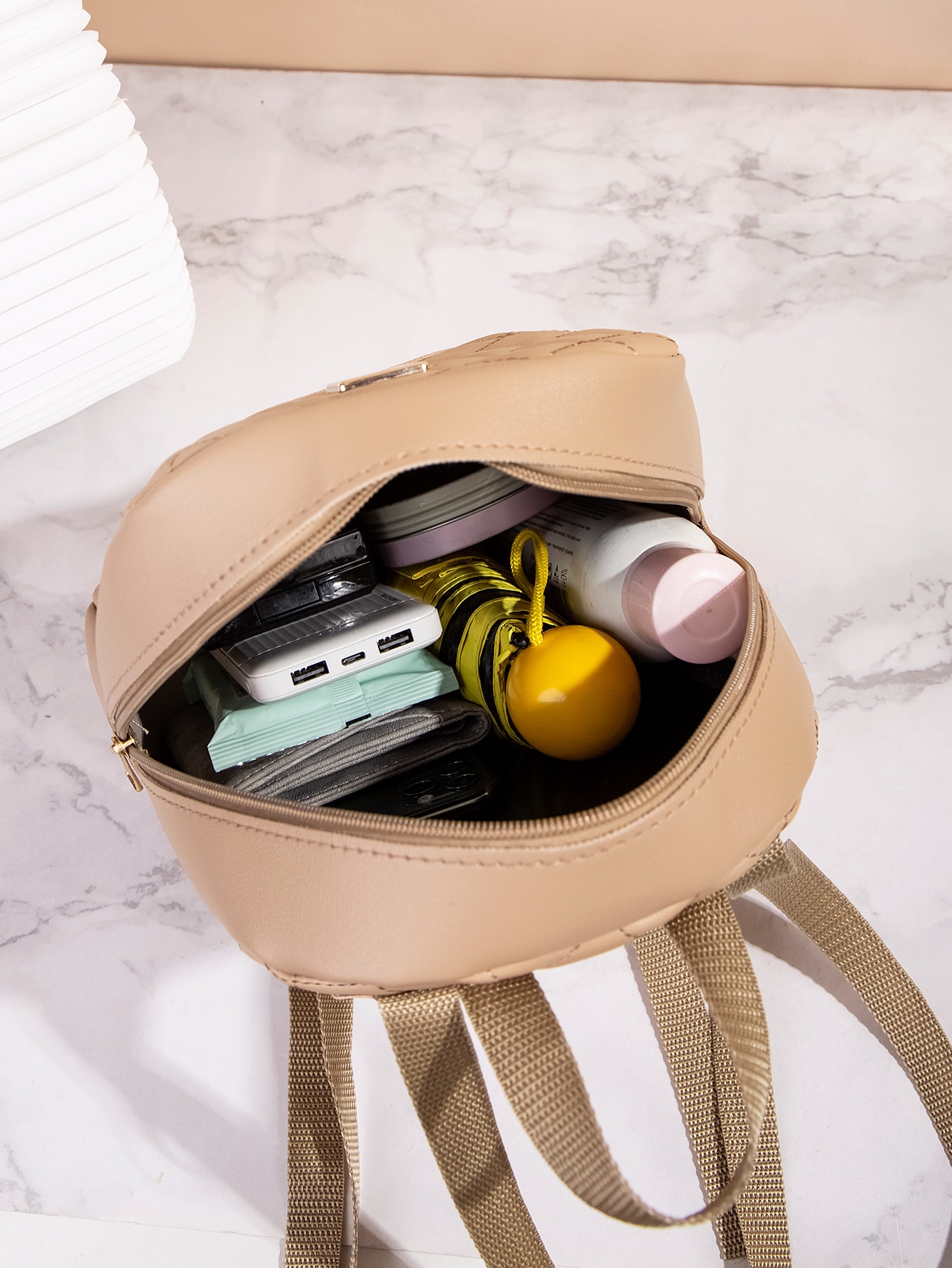 Quilted pattern front zipper back backpack