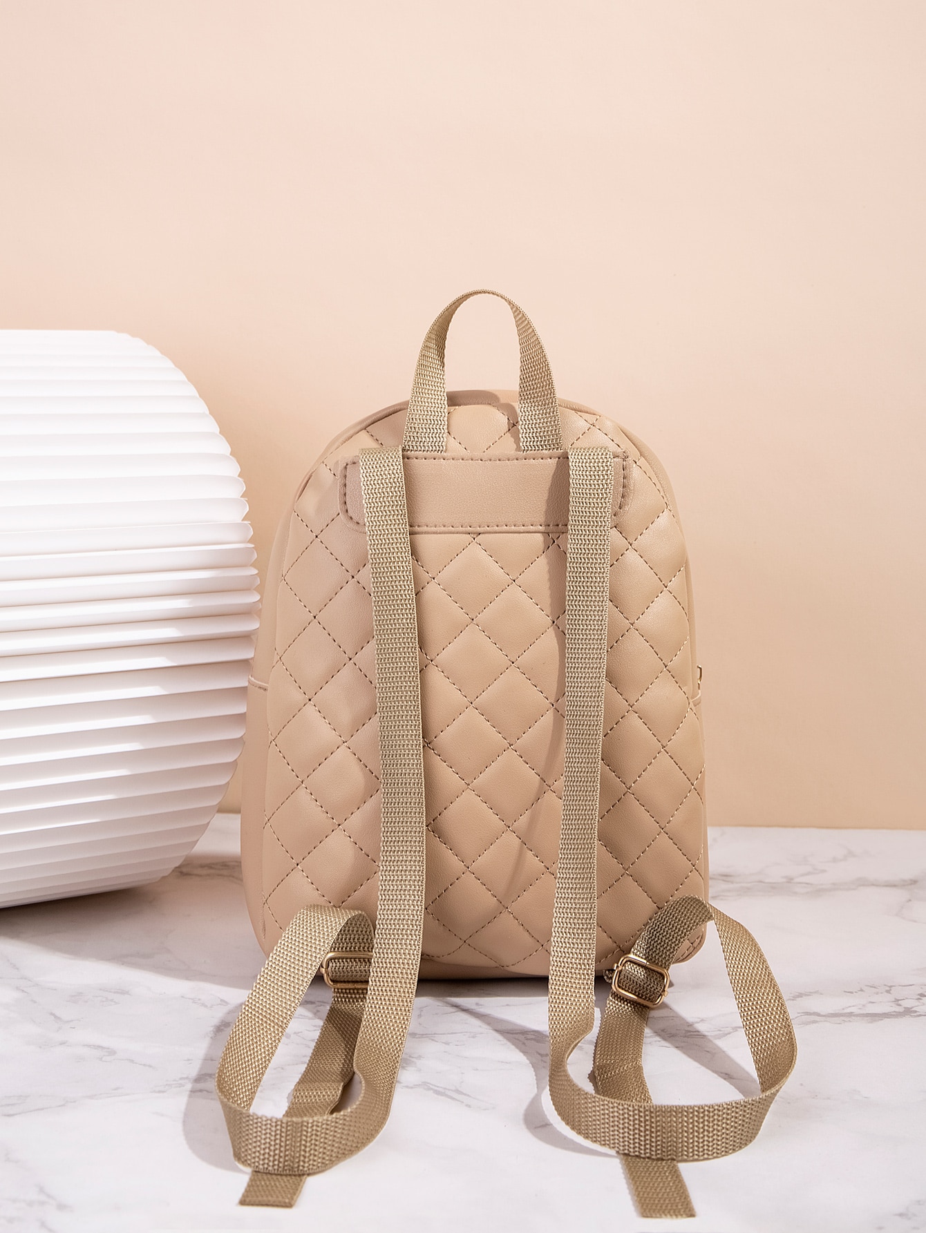 Quilted pattern front zipper back backpack
